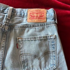 Used  faded 501 Levi’s jeans with hole in front